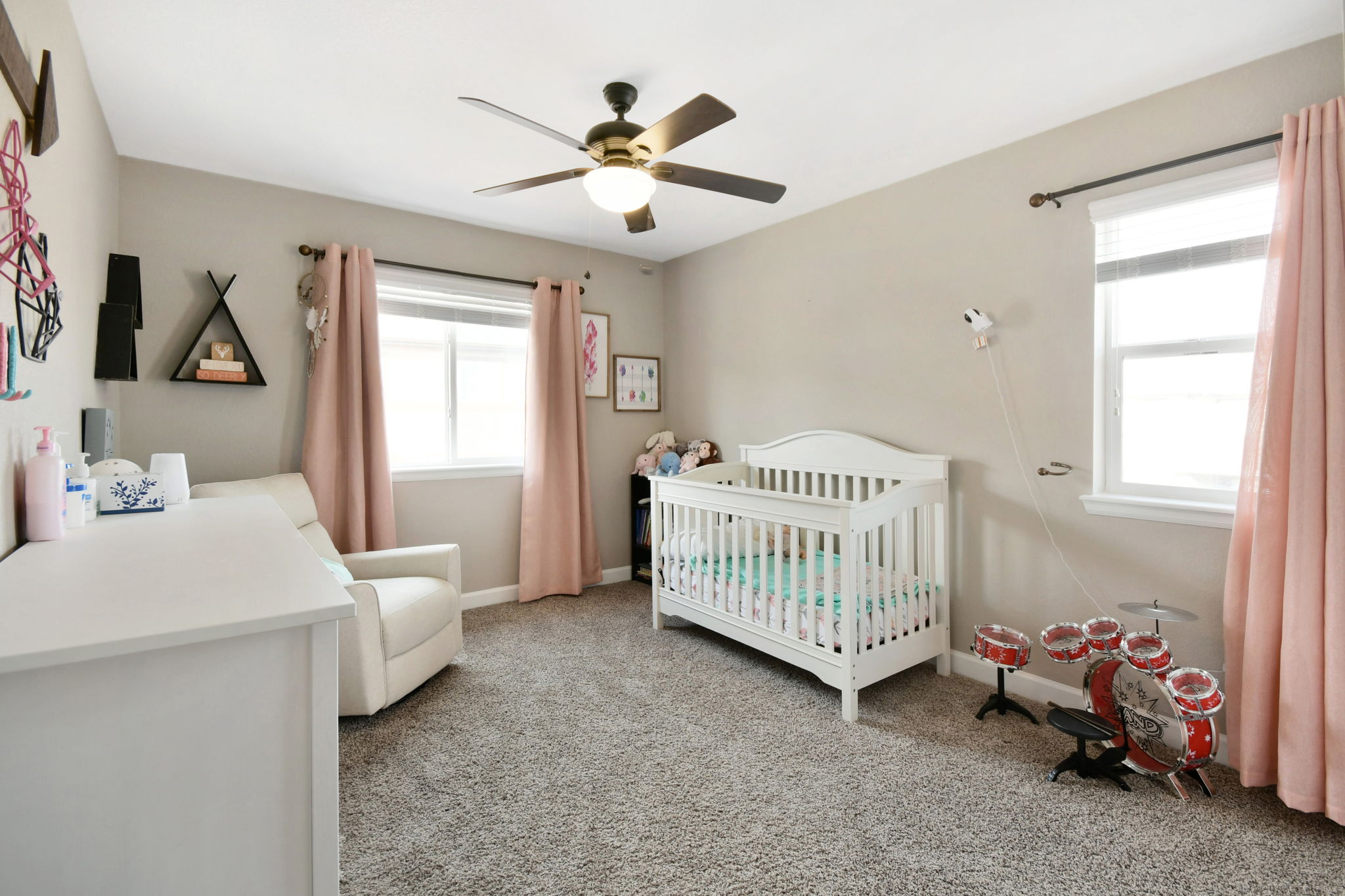 Bright 2nd bedroom with ceiling fan and 2 window
