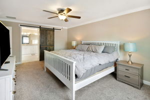 Owner's suite with barn door to bathroom