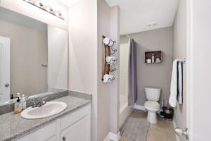 Bathroom 2 with tile floors and stone counters