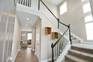 Dramatic open staircase in entry foyer