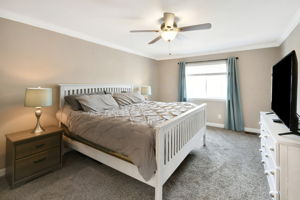 Owner's bedroom with Crown moulding and ceiling fan