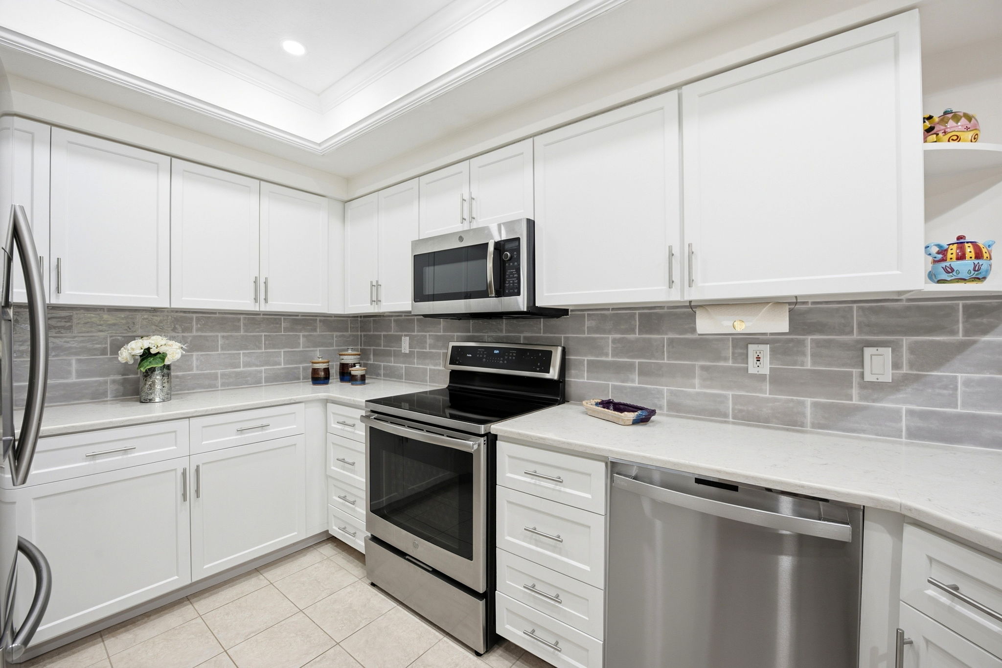 Subway backsplash, stainless steel appliances, and plenty of lighting