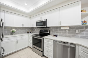 Subway backsplash, stainless steel appliances, and plenty of lighting