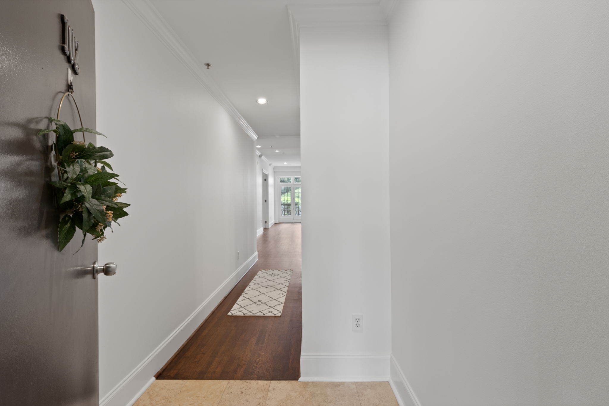 The entry foyer and hallway welcome you home to newly refinished hardwood floors and freshly painted rooms throughout