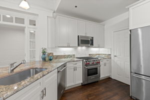 Updated kitchen with luxury appointments, including Wolf gas range, stainless farmhouse sink and granite countertops