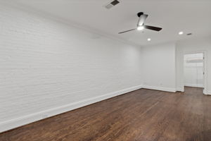 Second Bedroom with painted brick walls is ideal for combined space for king-sized sleep, home office, formal dining room, home gym, you name it with walk-in closet.