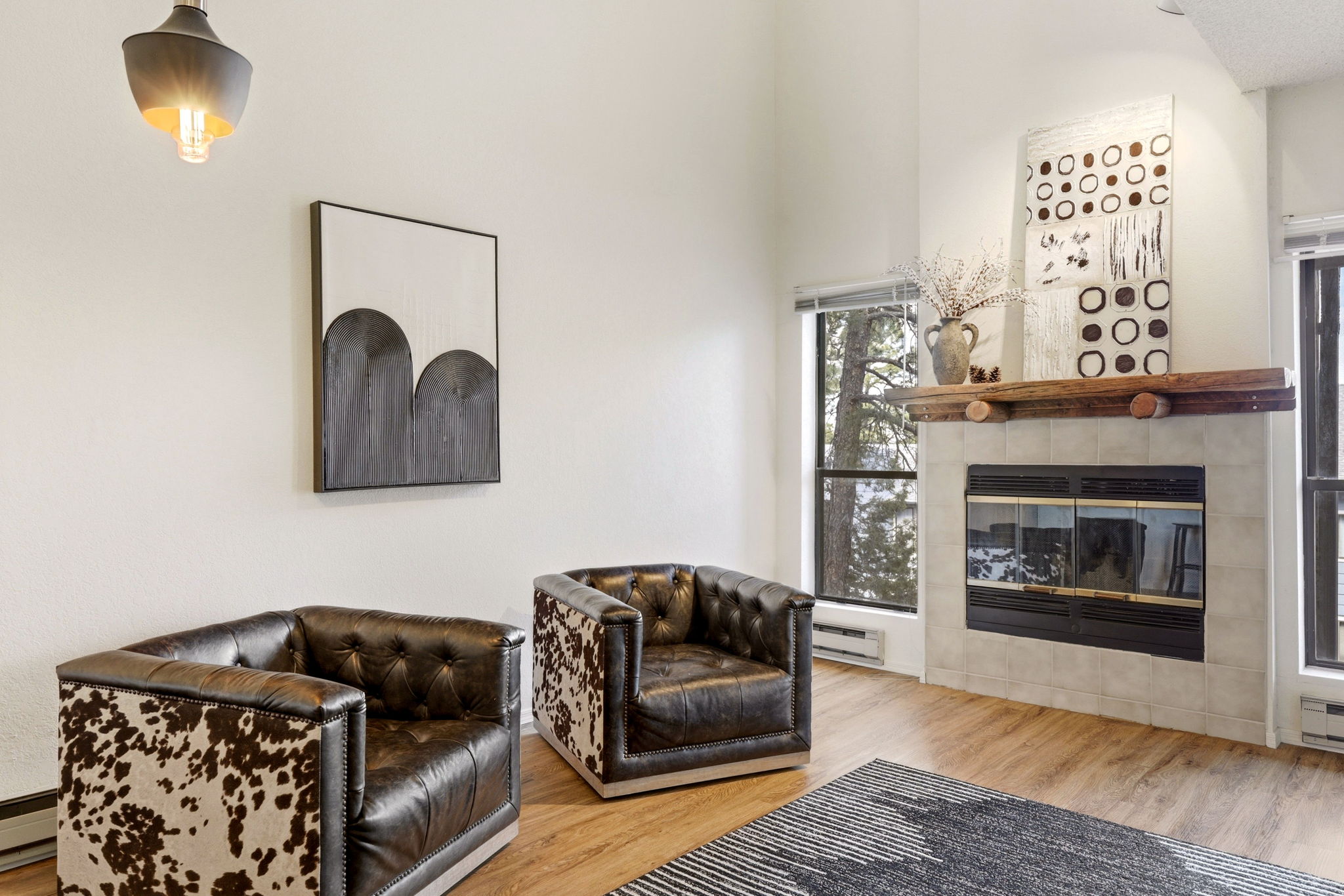 Sun-drenched living space with dramatic ceilings and inviting fireplace.