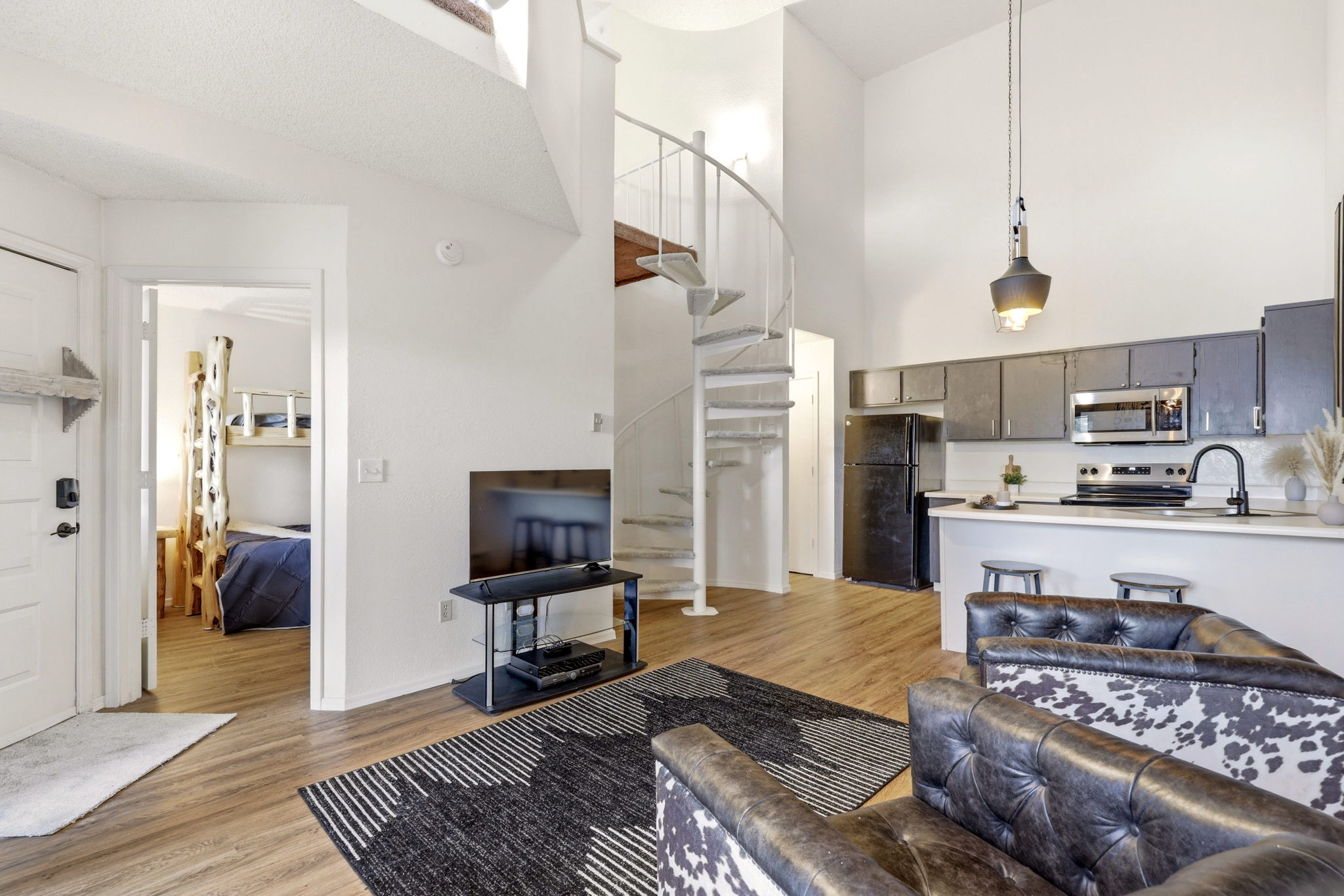 Spiral staircase leading to a spacious master loft retreat.