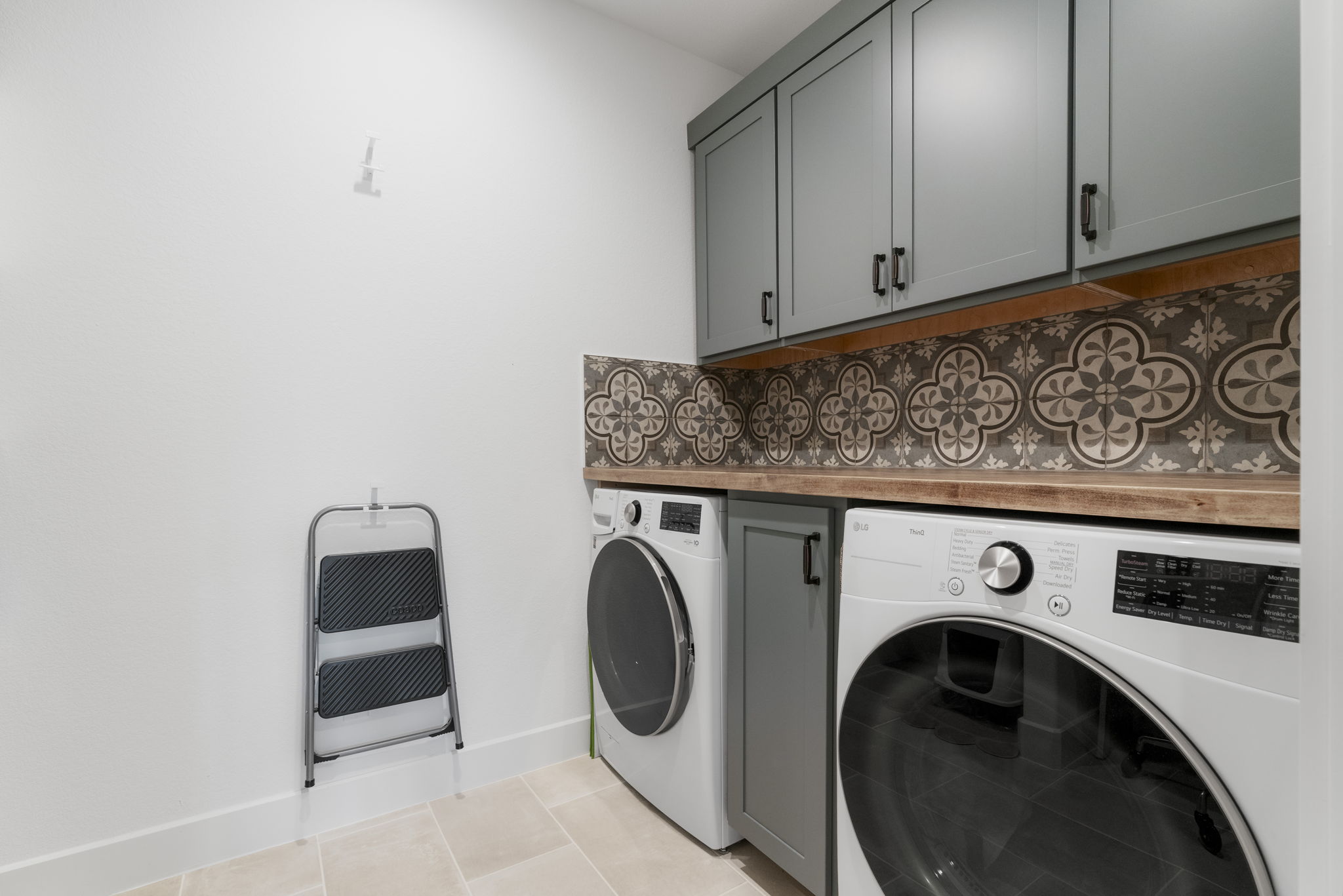 Laundry room is located in the center of the home with plenty of storage and counter space available. Not shown open shelving and space for extra refrigerator. Prep and plumbed for refrigerator.