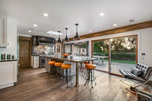 Kitchen has reclaimed wood flooring