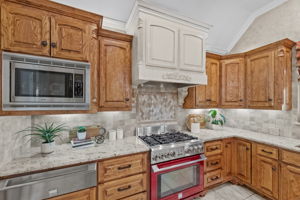 The kitchen was remodeled in 2013: Solid cabinets, under and over cabinet lighting, granite, Kenmore Elite Pro Range with 6 burner gas cooktop and electric convection range, warming drawer, convection microwave, fridge, and internal blower range hood.