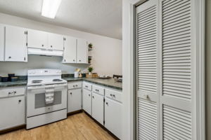 The kitchen features plenty of cabinet space ...