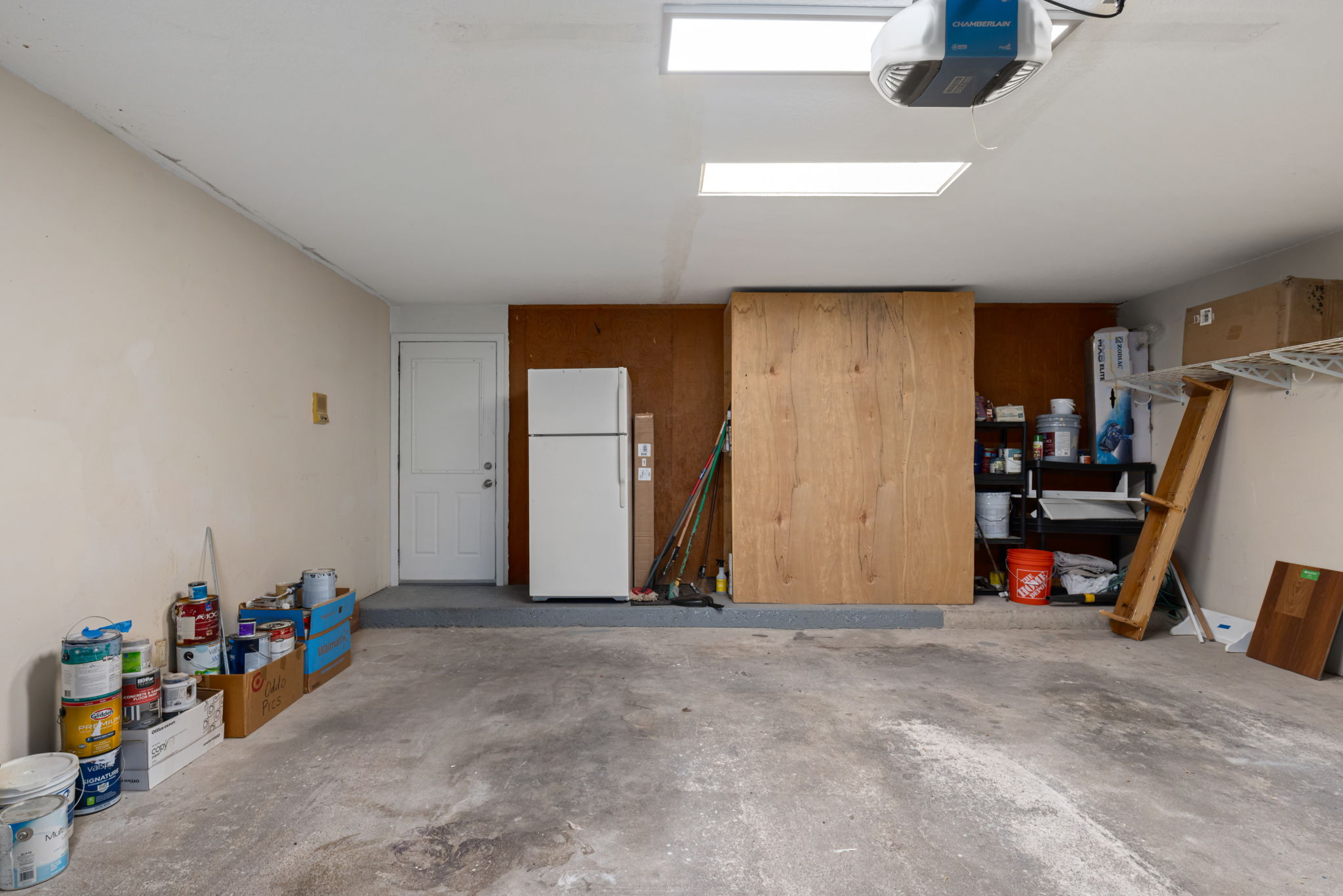 Two-car garage with skylights. Door to guest quarters