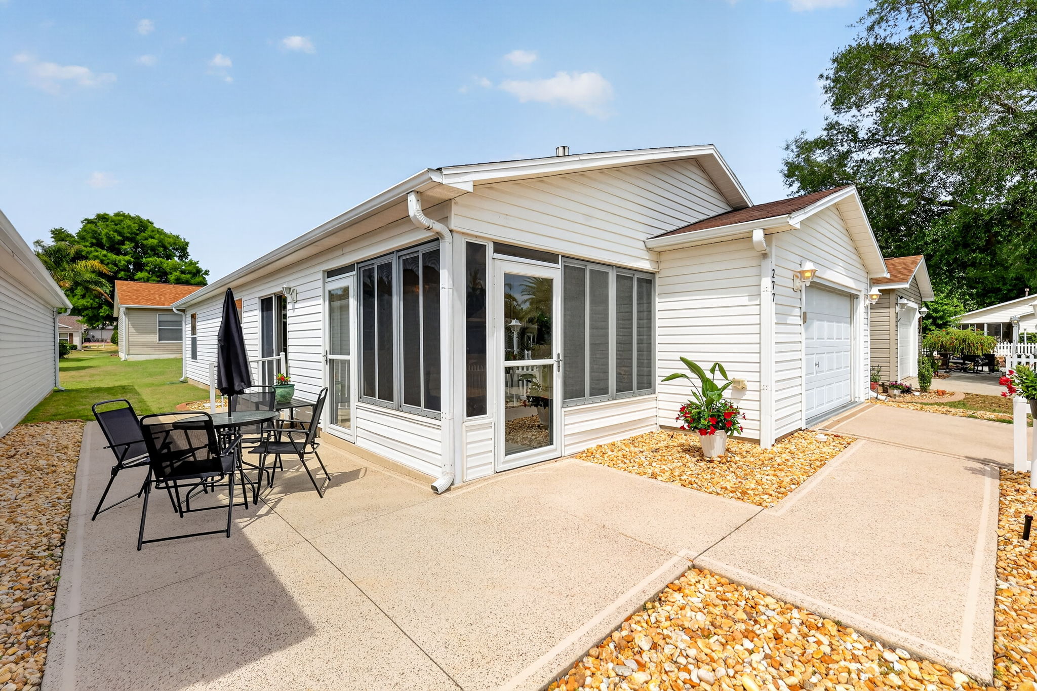 SPACIOUS Front and Side Patios with LOW-MAINTENANCE stone landscaping
