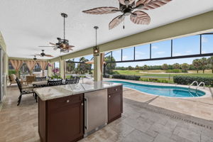 Swimming Pool, Lanai, and Outdoor Kitchen with Golf Front Views