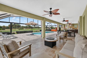 Swimming Pool, Hot Tub, Lanai, and Outdoor Kitchen with Golf Front Views