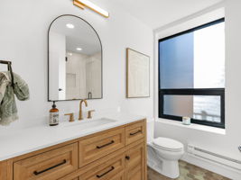 Central full bathroom just off of the kitchen.