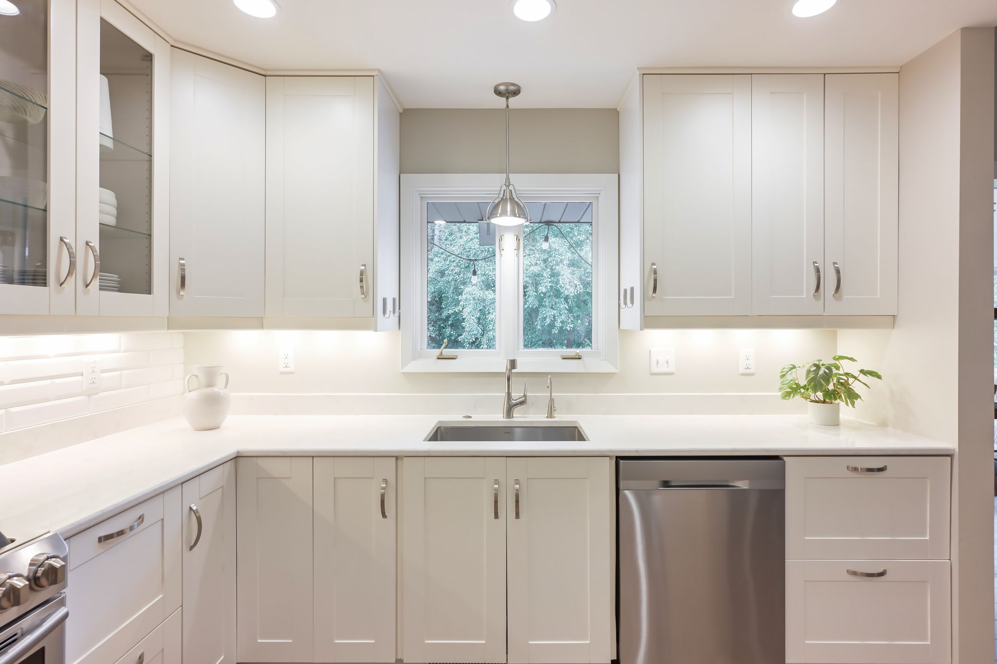 The look out window over the kitchen sink provides great views of the backyard patio while drenching the space in natural light.