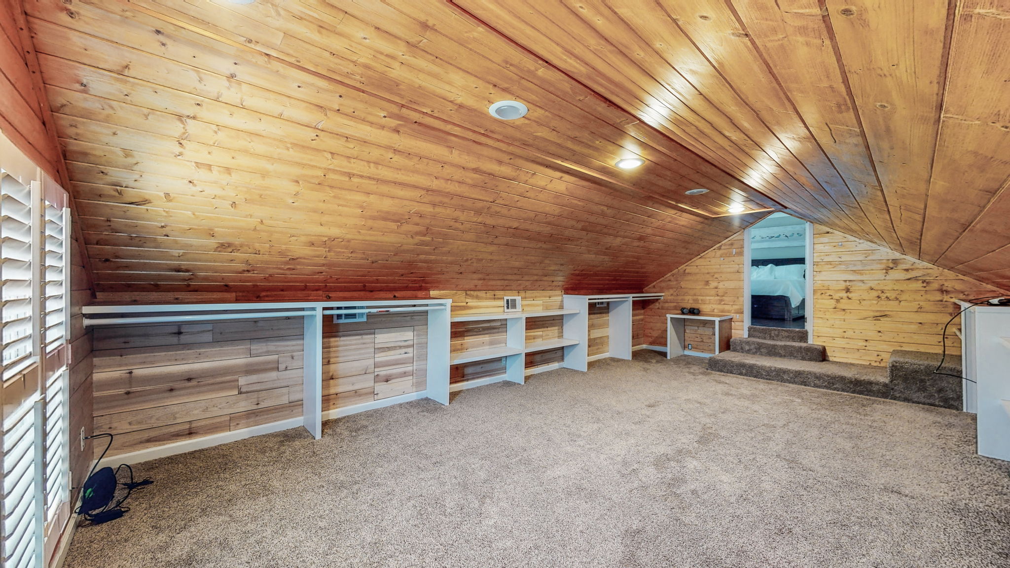 Hanging rods and shelves galore, and plenty of natural light occupy this spacious closet.