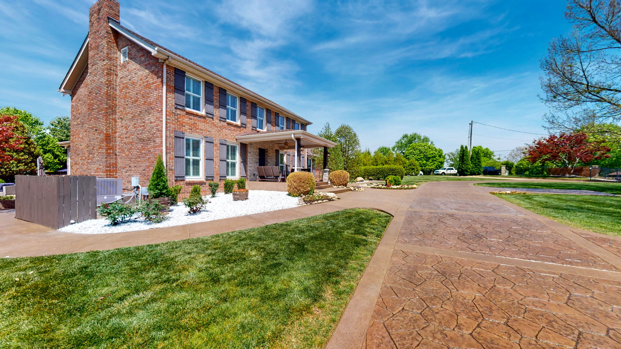Stunning colored, stamped concrete circular driveway leads to this beautiful park-like property.
