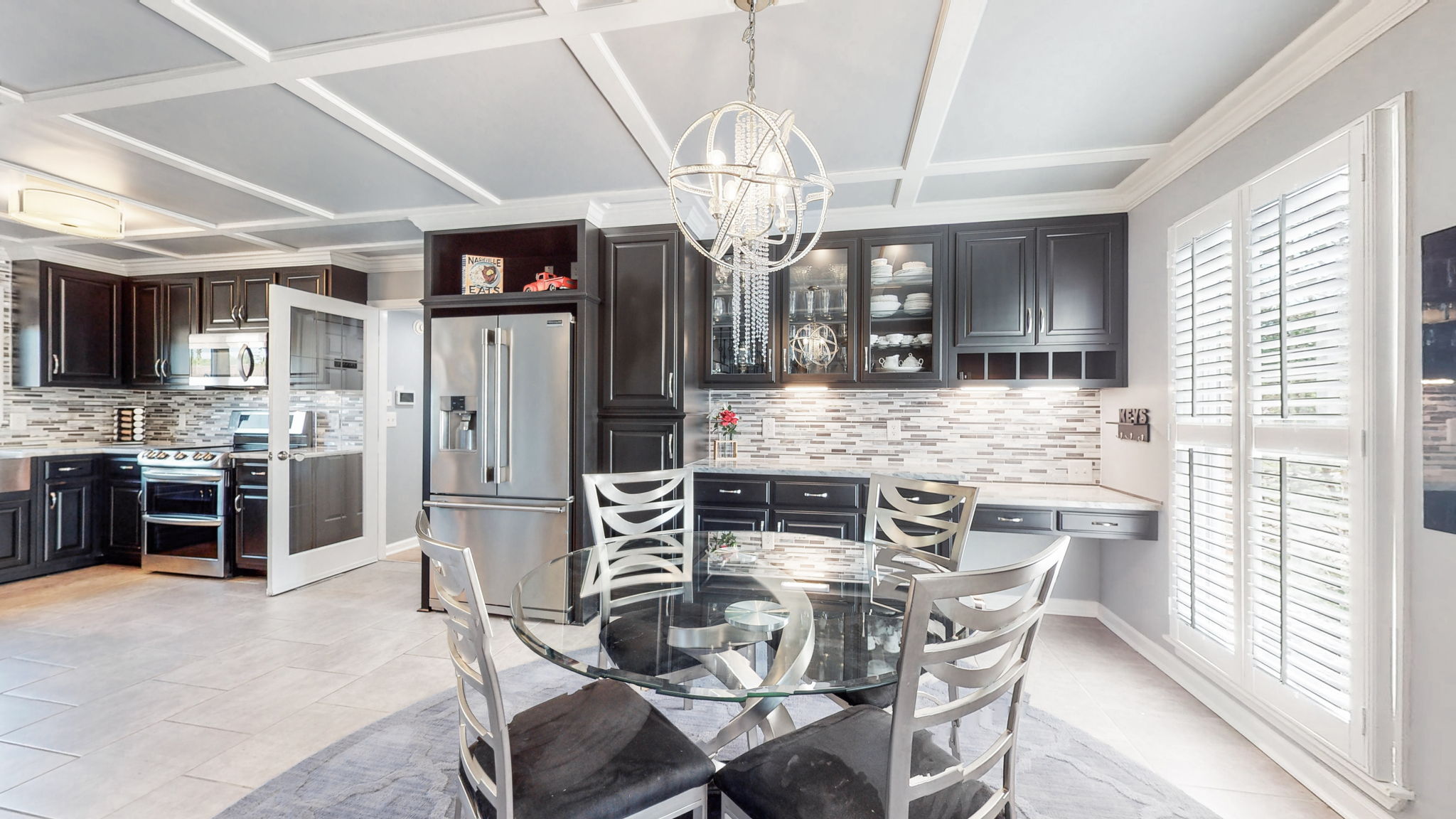 A large breakfast area with plenty of natural sunlight overlook the beautifully landscaped front yard.