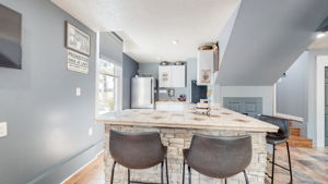 A wet bar with a full-sized refrigerator, a wine cooler and sink.  Abundant seating occupy this inviting, entertaining area.