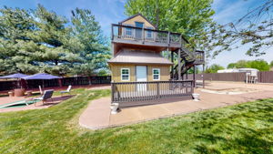 Kids and adults alike will enjoy this enormous treehouse with an extra room in the front and storage in the back of the downstairs.  In the background you see parking and a power hookup for a large RV.