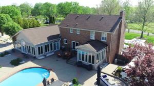 Two amazing sunrooms overlook this resort-like backyard.