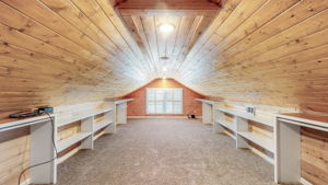 Enhanced with cedar walls, this magnificently large walk-in closet off the master suite will not disappoint.  The vaulted ceiling is beautiful stained oak.