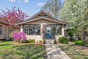 Classic stucco Bungalow with flowering trees