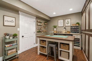 Virtually staged as a Craft Room.
