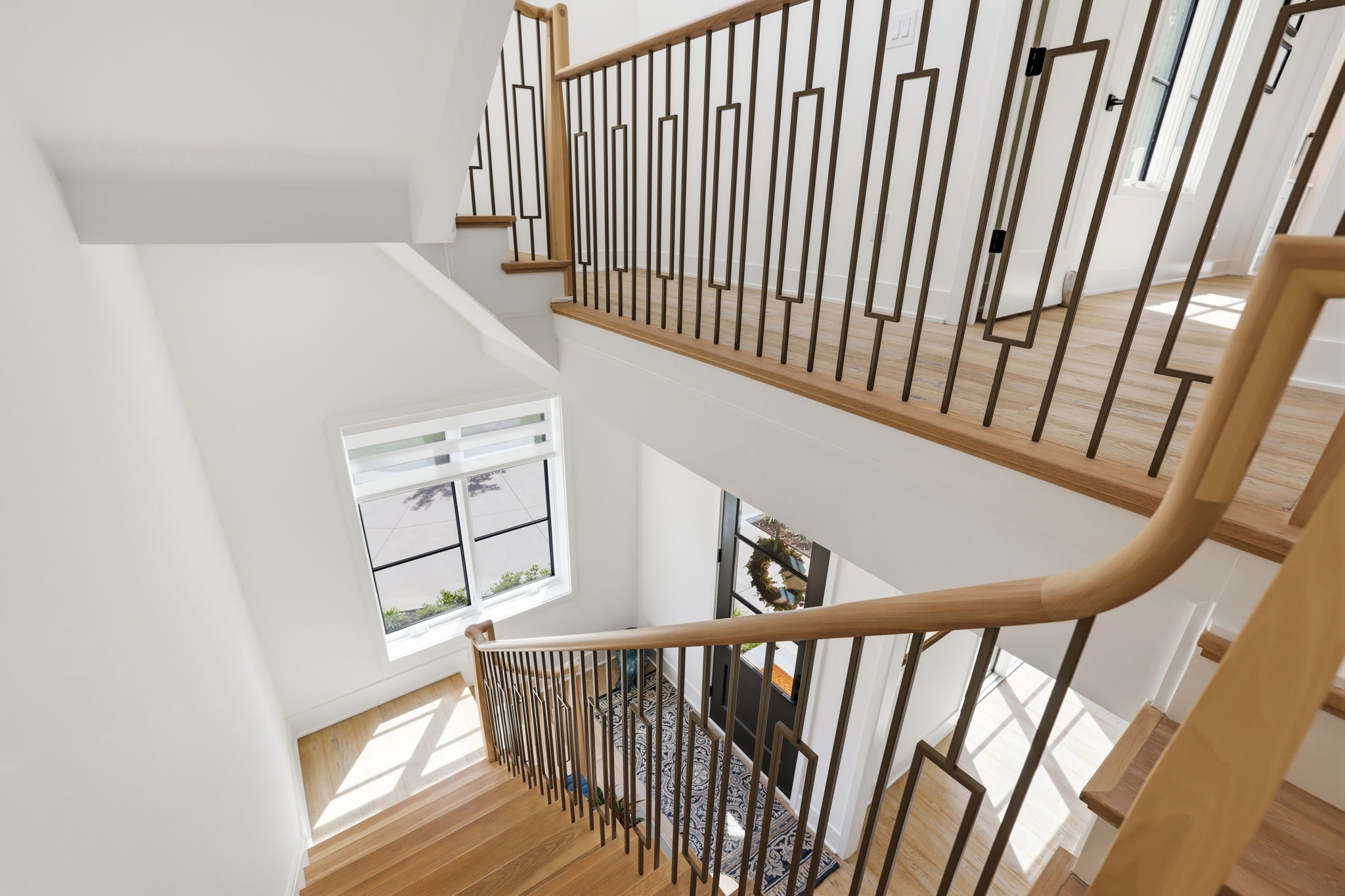 Refined staircase with custom millwork and railing detail.