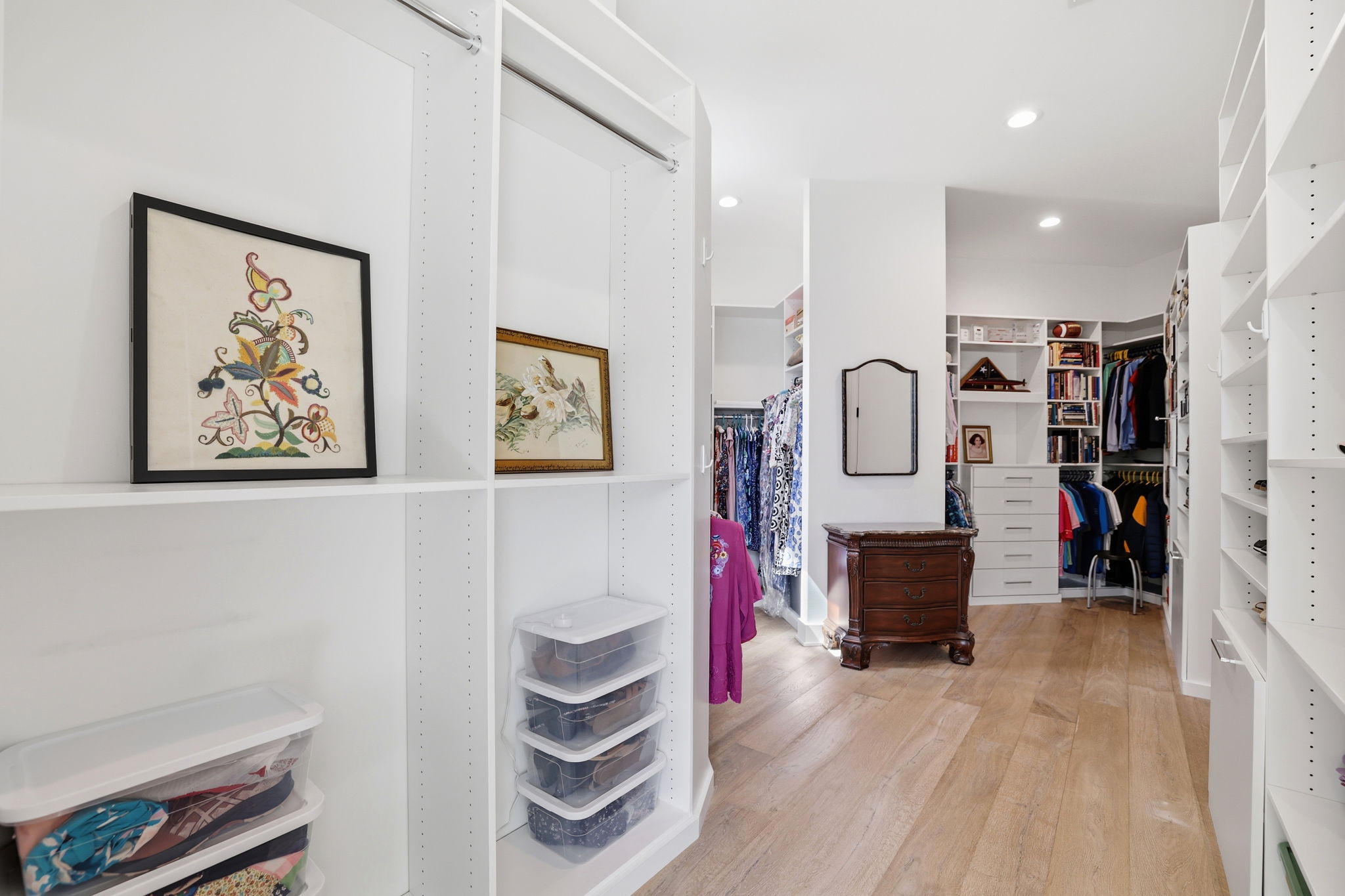 A beautifully appointed and custom walk-in closet offering dedicated his-and-hers spaces