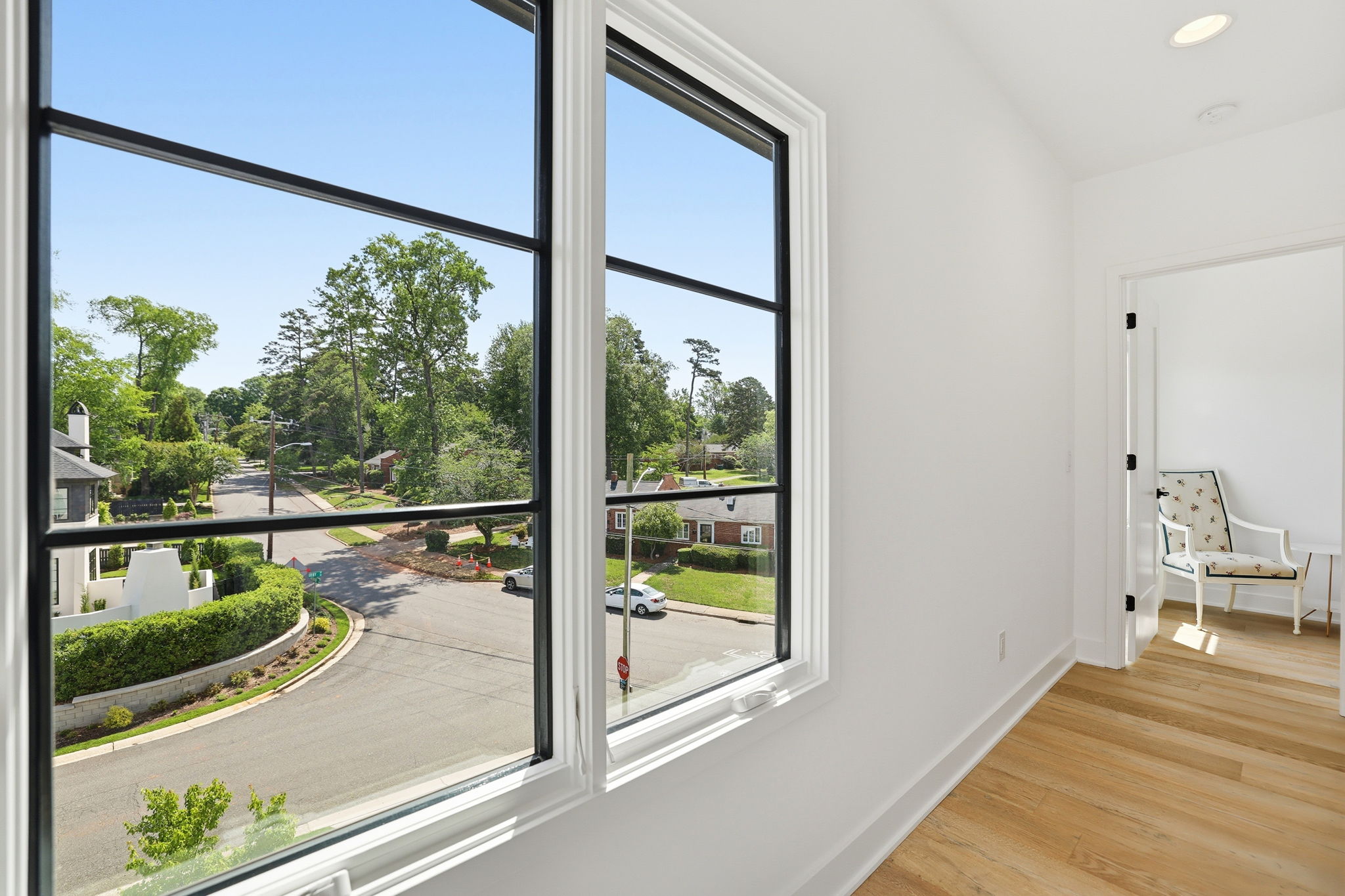 A curated gallery-style hallway enhanced by natural light and a truly beautiful view beyond