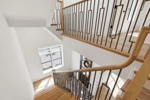 Refined staircase with custom millwork and railing detail.