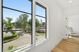 A curated gallery-style hallway enhanced by natural light and a truly beautiful view beyond