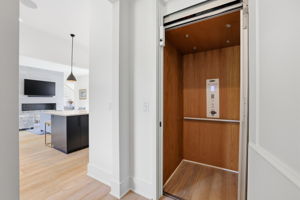 Savaria elevator with oak-paneled interior & access to all levels.