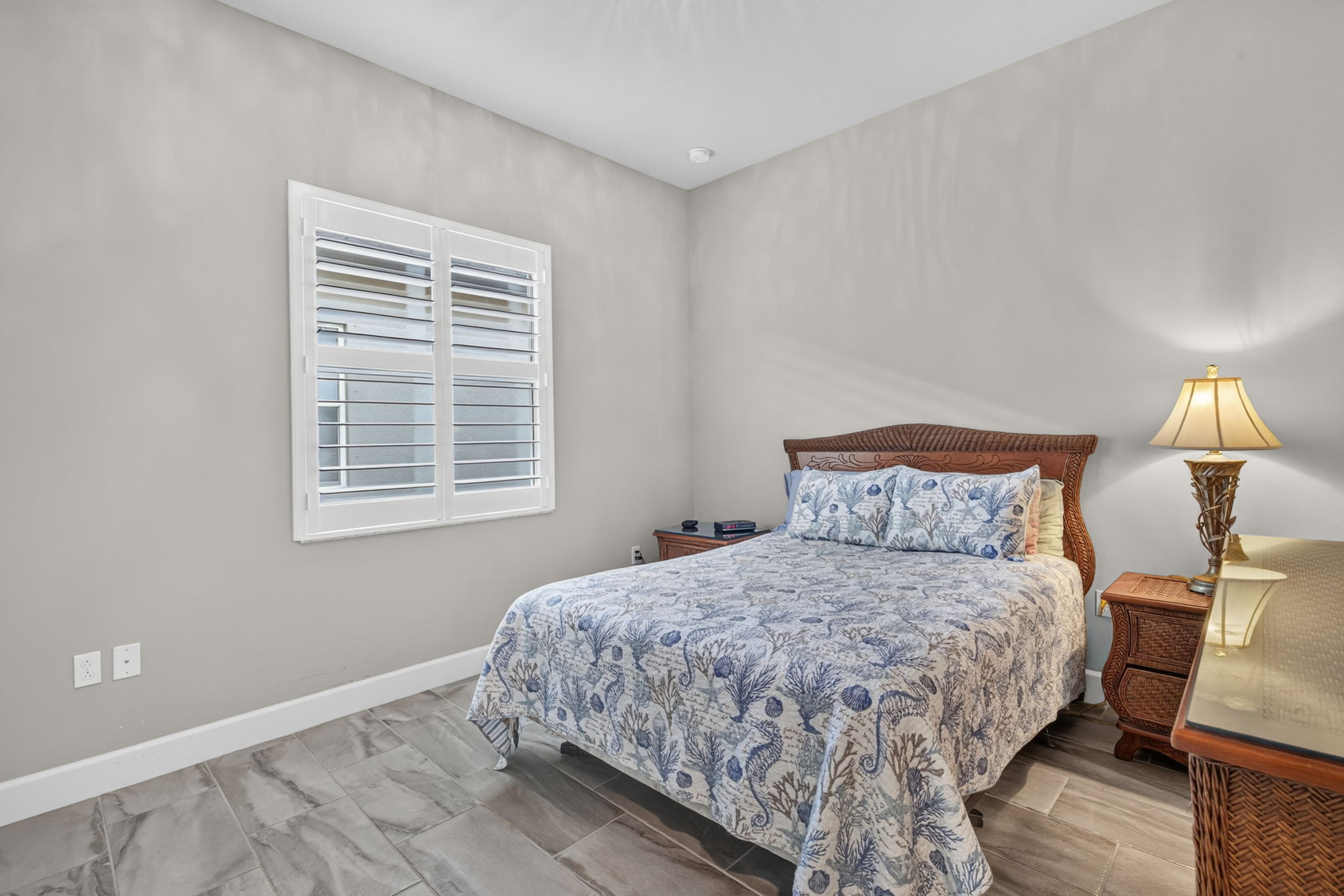 Continuation of plantation shutters and beautiful plank tile flooring present! Nice sized closet here, too!