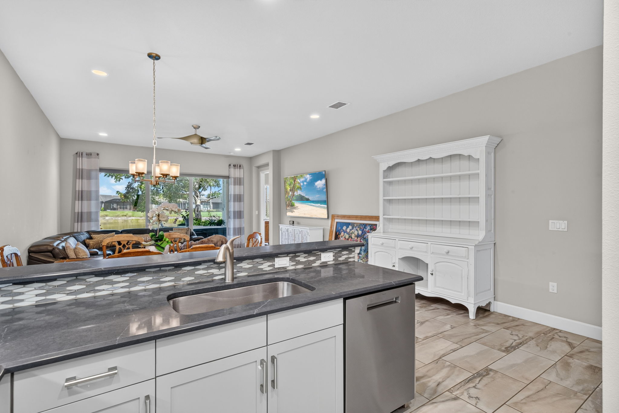 Oversized single sink present here. The higher ledge is a great area to put food when you are entertaining!