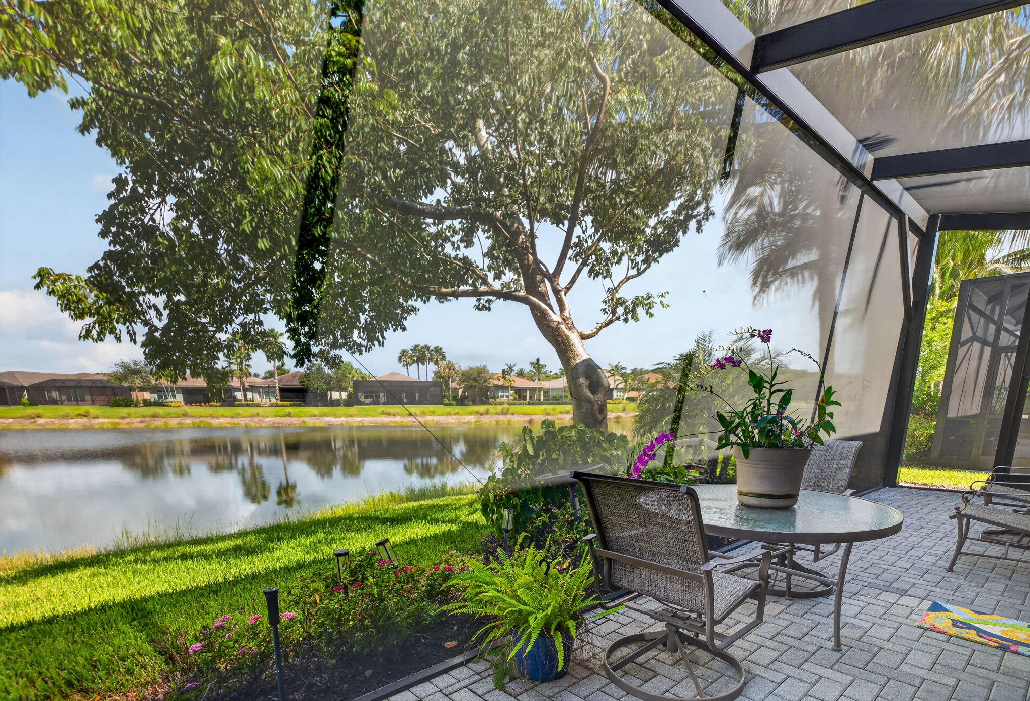 THIS EXPANDED LAKEFRONT PATIO IS SCREENED THE ENTIRE WIDTH OF THE VILLA! Ahh! Enjoy!