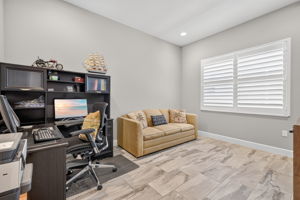 Den holds a sleeper sofa, corner desk and a tv console piece, too! Note the plantation shutters here, too!