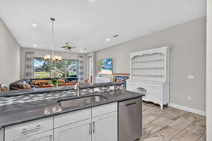 Oversized single sink present here. The higher ledge is a great area to put food when you are entertaining!