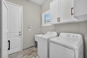 Built-in cabinets for additional storage, plantation shutters to match all other windows and a utility sink. What more could you ask for? BTW, you can't see to appreciate the tankless hw tank or the whole house generator!