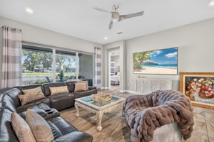 Spacious great room is adjacent to primary suite; all with high impact glass and doors!