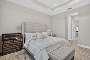 His and Her walk-in closets in hallway to primary bath...