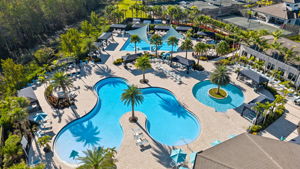 Resort pool with beach entance, resistance pool, and lap pool in distance photo.