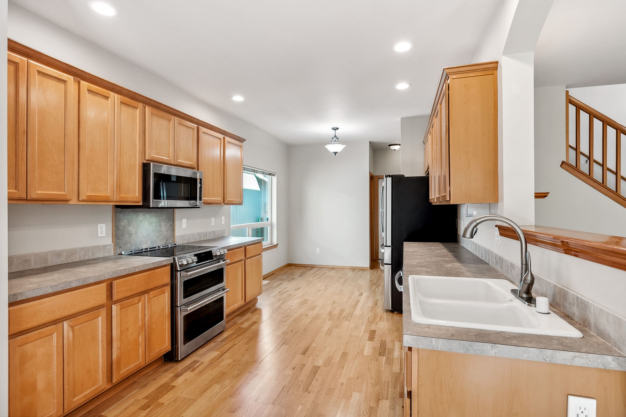 Spacious galley style kitchen with an eating space.