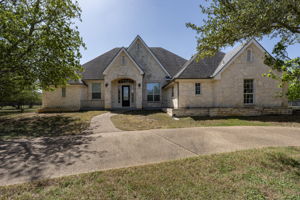 Texas stone exterior with roof line peaks elevates this homes curb appeal.