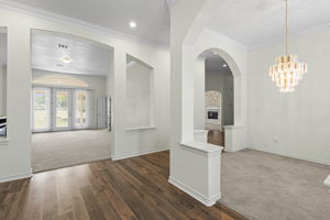 As you enter you are welcomed by high ceiling and a direct view of the back yard green space.