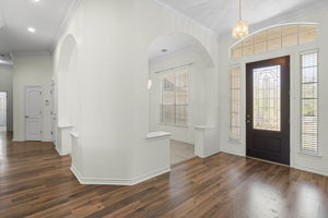 The inviting entry foyer features wood-like flooring & opens up to the formal dining.